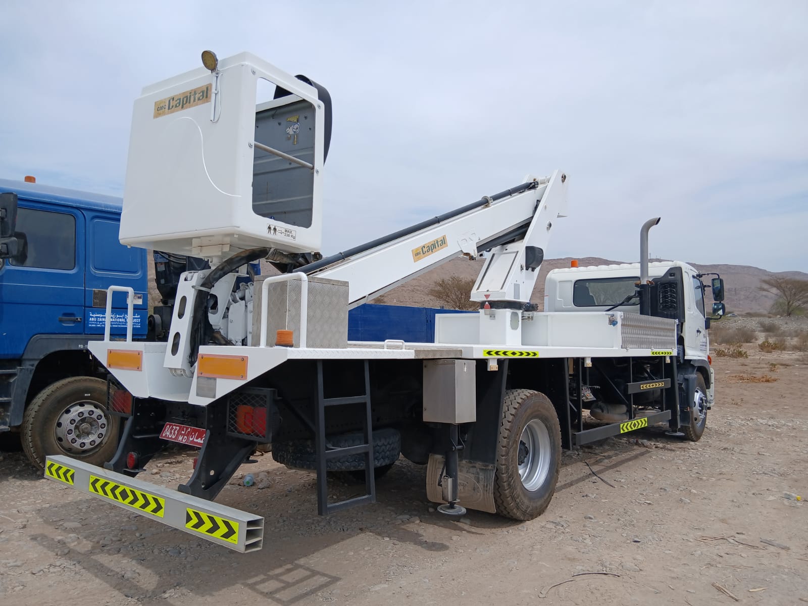 Man lift and bucket truck support vehicle in field operation